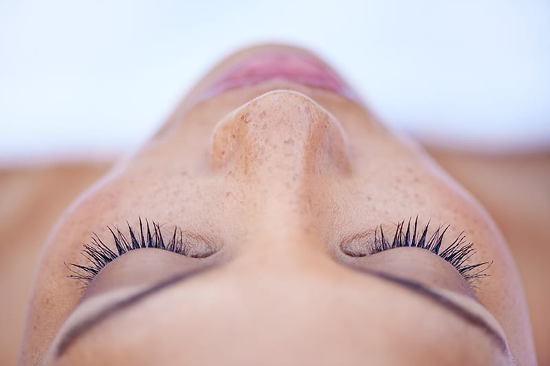 Cropped shot of an attractive young woman lying on her back.